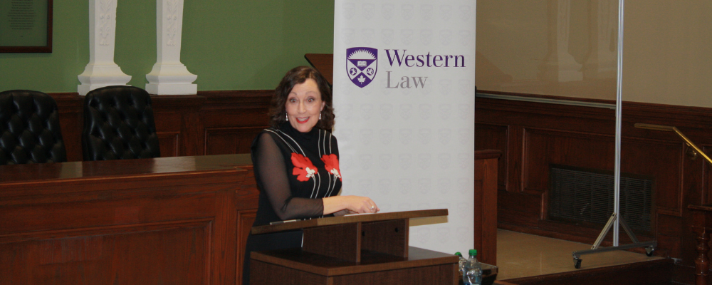 Professor Aileen Kavanagh stands in the Moot Court Room at Western Law delivering the Coxford Lecture